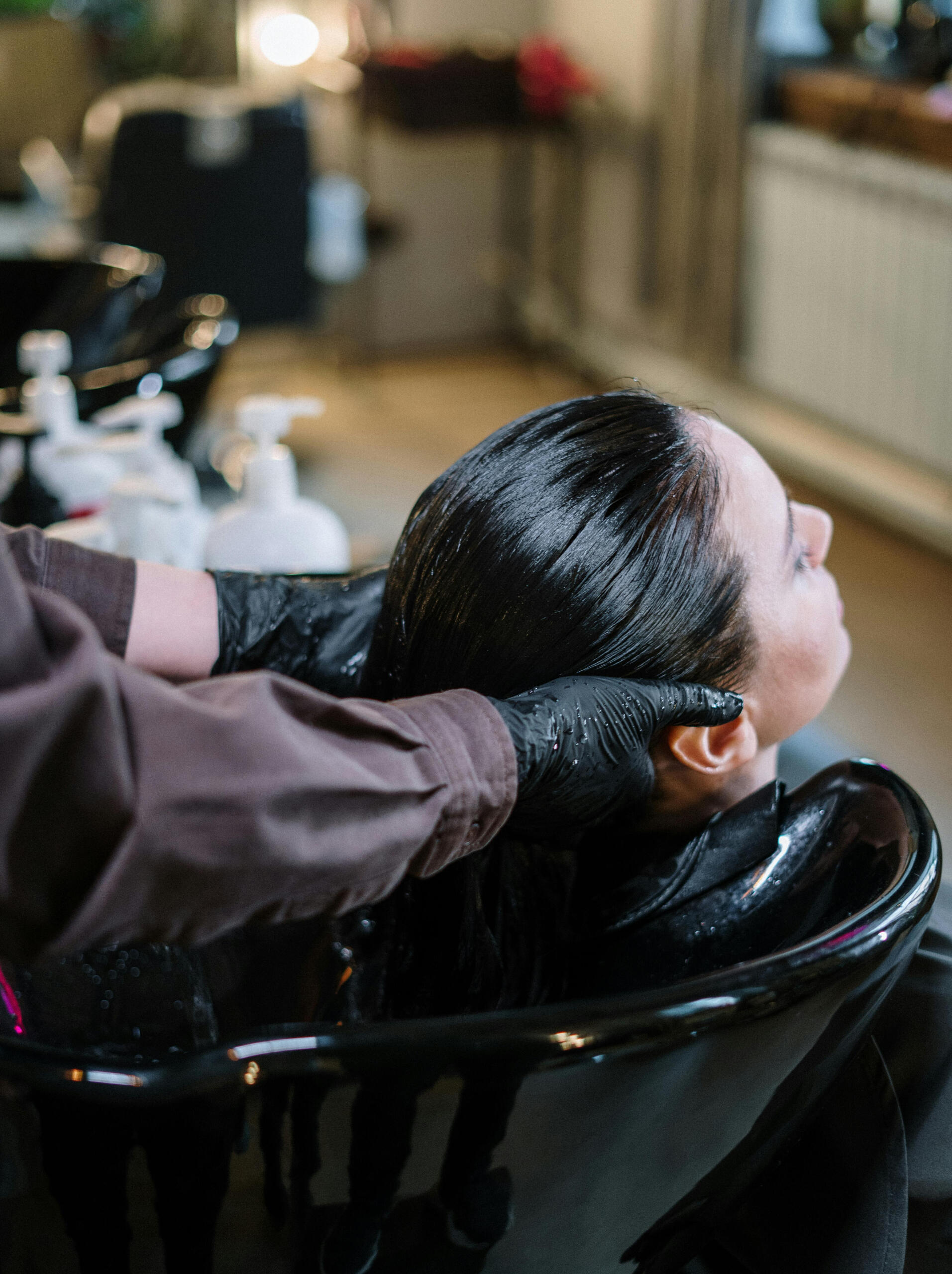 A woman getting her hair washed at a hair salon in Bundang