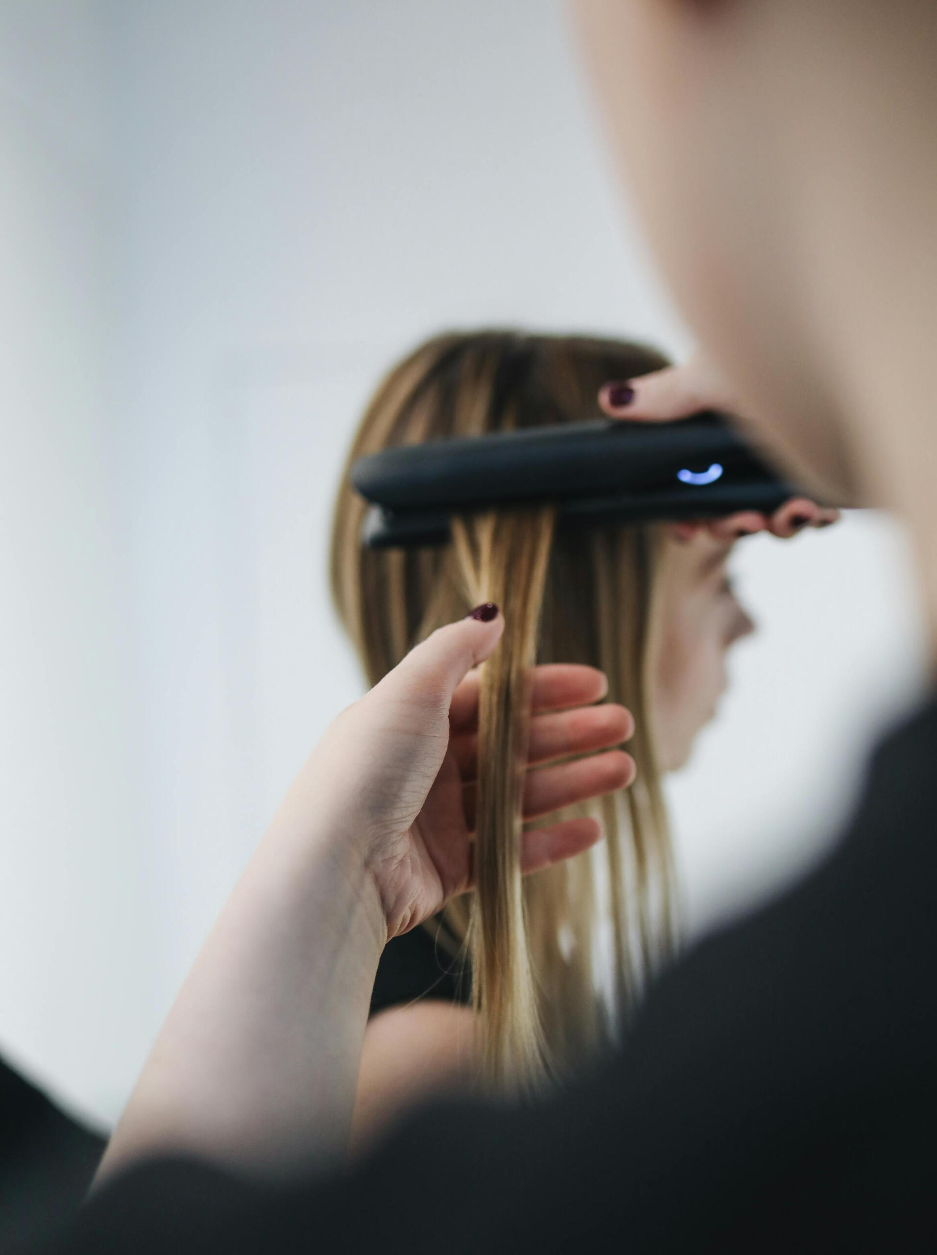 A woman getting her hair ironed at Juno Hair Seohyeon